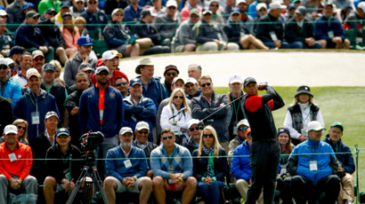 A crowd behind Tiger Woods at a golf event.