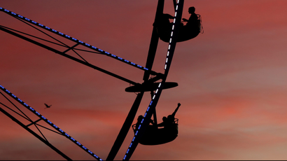 People ride a ferris wheel at sunset during Desert Trip music festival at Empire Polo Club in Indio