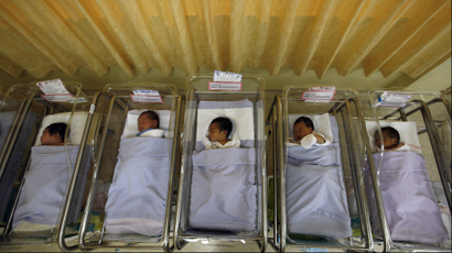 Five babies sleeping in incubators