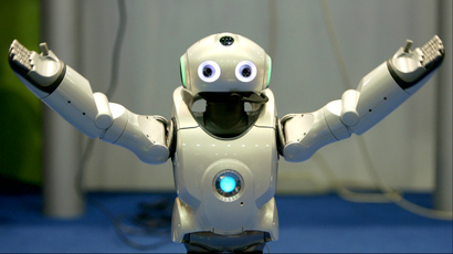 A robot gestures during a demonstration of its skill during the seventh Soccer World Championship.