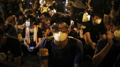 Student protesters sit on the main road outside the government complex where Hong Kong's Chief Executive Leung Chun-ying's office is located, Friday, Oct. 3, 2014 in Hong Kong.