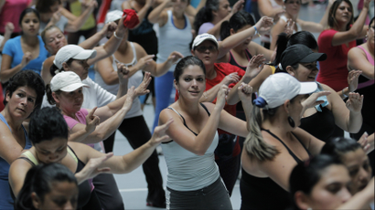 People participate in an aerobics class at the gymnasium of a sports center in Cartago.