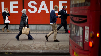 People walk past sale signs on Oxford Street in London, Monday, Dec. 24, 2012. Sales in some UK stores began on Christmas Eve. People walk past sale signs on Oxford Street in London, Monday, Dec. 24, 2012. Sales in some UK stores began on Christmas Eve.