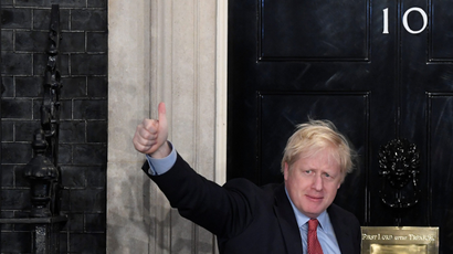 Britain's Prime Minister Boris Johnson gestures as he arrives at 10 Downing Street
