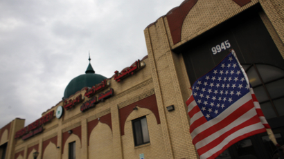 An American flag hangs on a car outside the American Muslim Society mosque in Detroit, Michigan