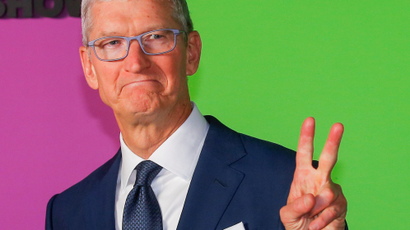 Apple CEO Tim Cook gives crowds the peace sign