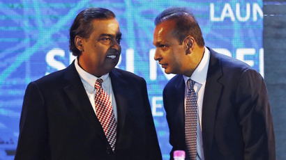 Anil Ambani talks to his brother Mukesh during the launch of Digital India Week in New Delhi