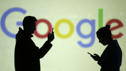 Silhouettes of mobile users are seen next to a screen projection of Google logo in this picture illustration taken March 28, 2018.