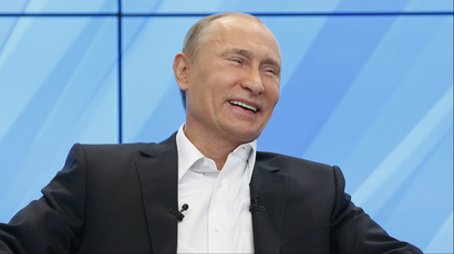 Vladimir Putin laughs as he meets with supporters in Moscow.