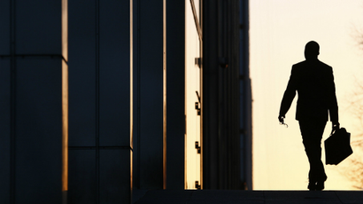 A worker arrives at his office in the Canary Wharf business district in London.