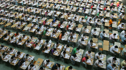 Students sit an English examination in the hall of a building in the Dongguan Technology Institute, in China's southern Guangdong Province, Monday, July 9, 2007. Some 1,200 students of different year levels were made to sit different exams in the hall in an effort to prevent cheating. (AP Photo/EyePress