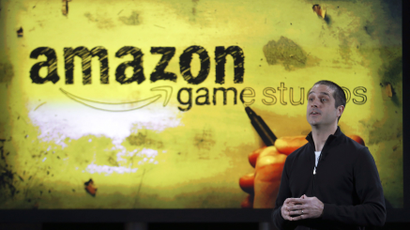 Amazon's vice president of games, Mike Frazzini speaks to media as he displays the Amazon Fire TV during a news conference in New York