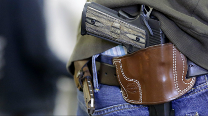 A gun owner wears his gun on his hip.