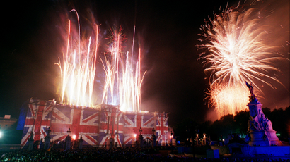 Fireworks light up the sky over Buckingham Palace, lit in colours of the Union flag after the Party At the Palace as part of the Golden Jubilee celebrations in London Monday, June 3, 2002. Britain's Queen Elizabeth has been the British monarch for 50 years, since the death of her father George VI in 1952. (AP Photo/Steve Holland