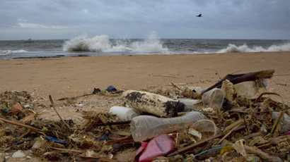 a plastic bottle lies among other debris washed ashore on the Indian Ocean beach of Uswetakeiyawa, north of Colombo, Sri Lanka.