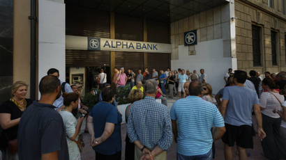 People stand in a queue to use ATM cash machine of a bank in central Athens, Sunday, June 28, 2015. Greece is anxiously awaiting a decision by the European Central Bank on whether to increase the emergency liquidity assistance banks can draw on from the country's central bank.