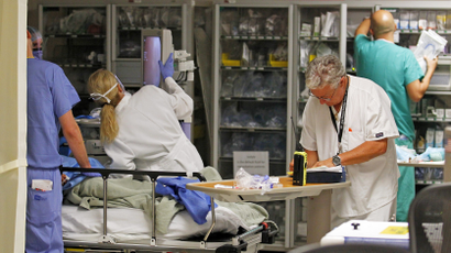 Doctors and nurses work on a patient in the Ryder Trauma Center at Jackson Memorial Hospital in Miami