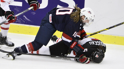 Megan Duggan of the U.S. fights for the puck with Canada's Lauriane Rougeau on the ice during the 2015...