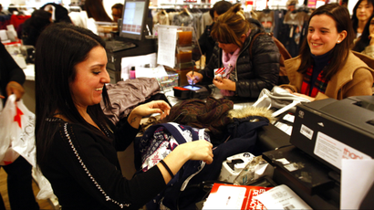 Customers shop at Macy's department store in New York November 25, 2011. Stores looking to grab as big a piece as possible of what is expected to be a middling holiday shopping season pushed post-Thanksgiving openings into Thursday evening, getting an early start on "Black Friday," the traditional start to the U.S. holiday shopping season. REUTERS/Eric Thayer