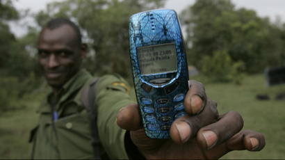 A Kenyan holding a mobile phone