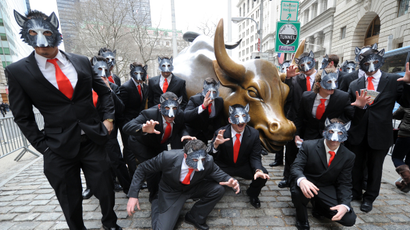 IMAGE DISTRIBUTED FOR PARAMOUNT PICTURES - A pack of “wolves” surround the Wall Street Bull, Tuesday, March 25, 2014, in New York, to celebrate the Blu-ray release of the hit movie The Wolf of Wall Street. (Photo by Diane Bondareff/Invision for Paramount Pictures/AP Images)