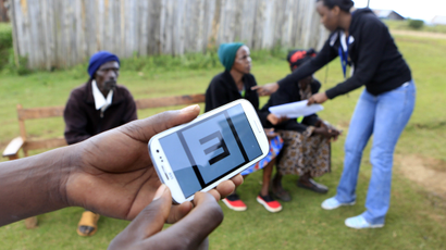 Eye patients wait in the background as a Smartphone apparatus is seen for eye examinations at a temporary clinic by International Centre for Eye Health at Olenguruone in the Mau Summit 350km (217 miles) west of Kenya's capital Nairobi, October 29, 2013.