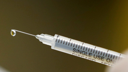 A syringe with a vaccine is seen ahead of Covid-19 vaccine trials.