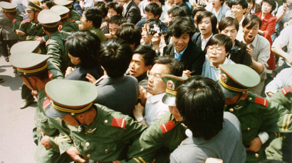 Crowds of jubilant students surge through a police cordon before pouring into Tiananmen Square on June 4, 1989 during a pro-democracy demonstration.