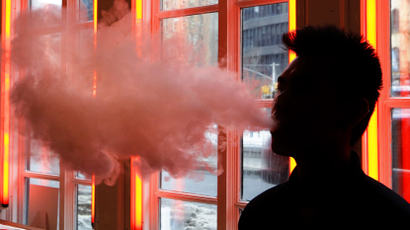 The silhouette of a person vaping.