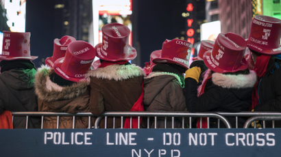 Revellers stand near a New York Police Department (NYPD) police cordon during New Year's Eve celebrations in Times Square, New York December 31, 2014.