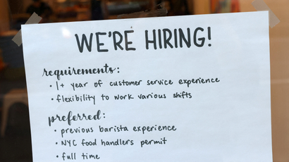 A hiring sign is seen in a cafe in New York City.