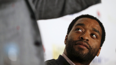 An image of Chiwetel Ejiofor, the Nigerian-British actor, looking up to someone speaking at an event.