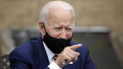 Joe Biden wearing a mask and pointing