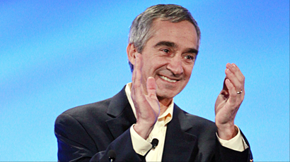 Patrick Pichette, chief financial office of Google, claps after an announcement.
