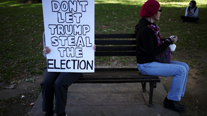 A person holds a placard near the White House after Election Day in Washington, U.S., November 4, 2020.