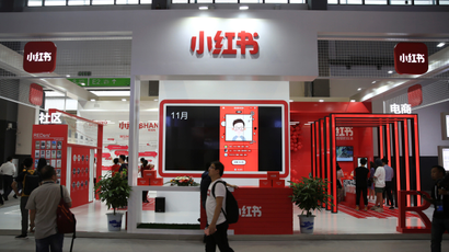 A man walks past the booth of Chinese startup Xiaohongshu