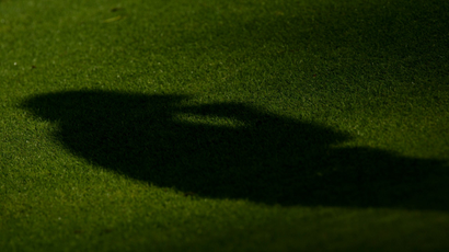 Shadow of a player on a golf course