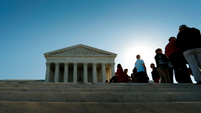 Visitors stand in line to watch arguments on the first day of the new term of the U.S. Supreme Court in Washington October 6, 2014.