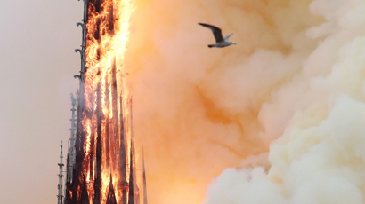 Smoke billows as fire engulfs the spire of Notre Dame Cathedral in Paris, France April 15, 2019.