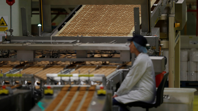 A worker inspects biscuits on the production line of Pladis' McVities factory in London