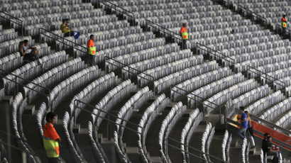 Stadium seats with only a few people sitting in them