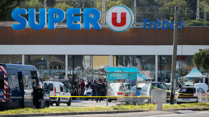 general view shows gendarmes and police officers at a supermarket after a hostage situation.