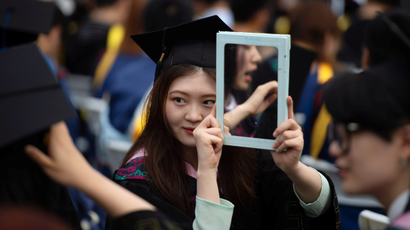 Graduates, including students who could not attend last year due to the coronavirus disease (COVID-19) pandemic, attend a graduation ceremony at Central China Normal University in Wuhan, Hubei province, China June 13, 2021. Picture taken June 13, 2021. REUTERS/Stringer CHINA OUT.
