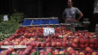 Peaches are displayed on a fruit vendor's stall at a grocery market in Athens.