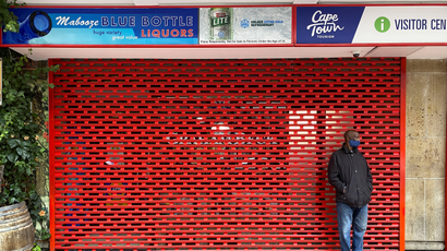A man stands outside a shuttered liquor store as new coronavirus disease (Covid-19) lockdown restrictions banning the sale of alcohol take effect in Cape Town, South Africa, June 28.