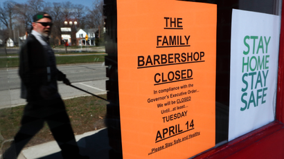 A pedestrian walks by The Family Barbershop, closed due to a Gov. Gretchen Whitmer executive order, in Grosse Pointe Woods, Mich., Thursday, April 2, 2020. The coronavirus COVID-19 outbreak has triggered a stunning collapse in the U.S. workforce with millions of people losing their jobs in the past two weeks and economists warn unemployment could reach levels not seen since the Depression, as the economic damage from the crisis piles up around the world.
