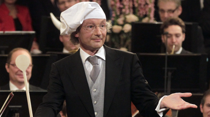 Maestro Franz Welser-Moest conducts the Vienna Philharmonic Orchestra with a wooden spoon as he wears a chef's hat, during the traditional New Year's Concert in the Golden Hall of the Vienna Musikverein in Vienna