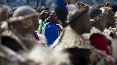 A Zulu elder wearing a South African flag listens to Zulu King Goodwill Zwelithini speak in Durban in 2015.