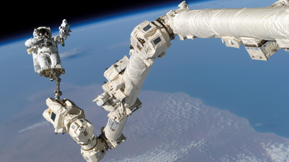 NASA astronaut Stephen K. Robinson is anchored to a foot restraint on the International Space StationÕs Canadarm2, built by Canadian technology company MDA, during his Space Shuttle missionÕs third session of extravehicular activity (EVA) August 3, 2005.