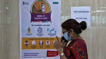 FILE PHOTO: A woman speaks inside a waiting zone area at a health clinic where COVID-19 vaccination is being given to healthcare workers in Kolkata